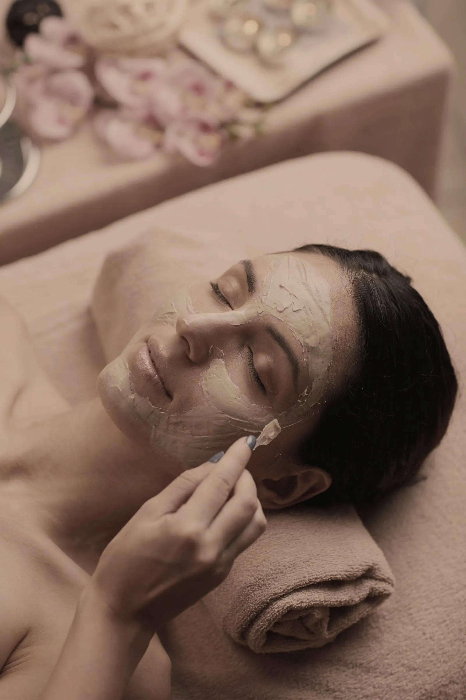Esthetician applying a nourishing facial mask in Freeport, Florida