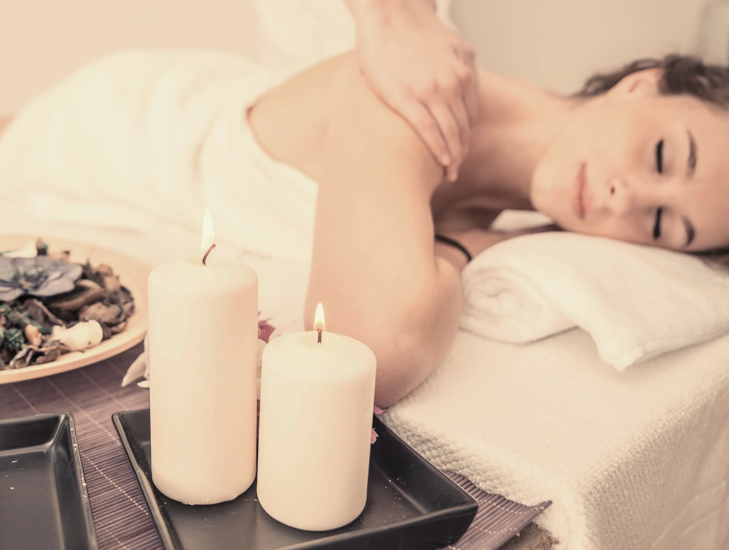 Client resting during a candlelit massage at The Freeport House Spa in Freeport, Florida